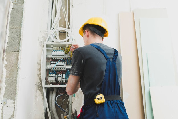 electrician fixing an electrical panel