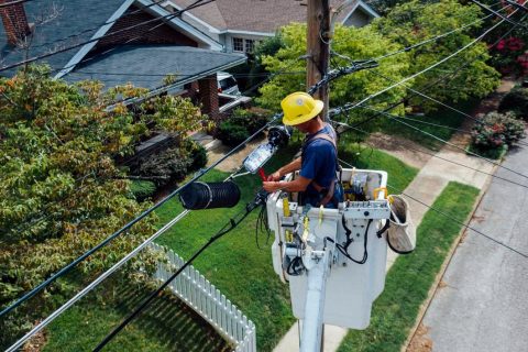 A licensed electrician fixing a power line