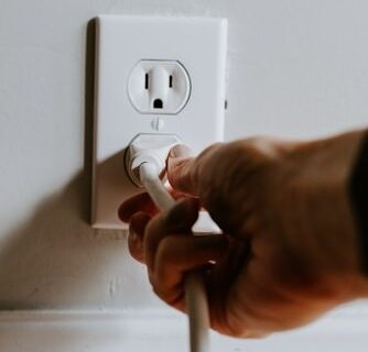 A man plugging in a socket