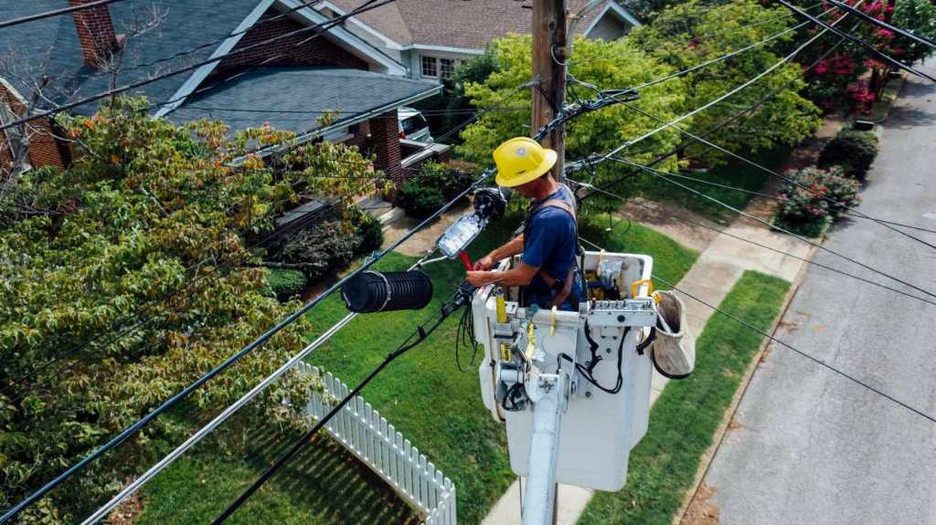A licensed electrician fixing a power line